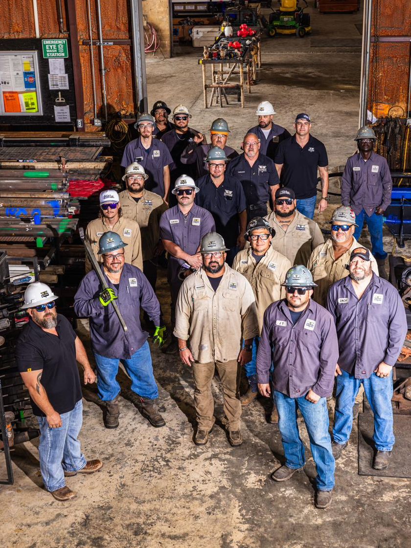 The Supreme Production Services crew assembled in the shop bay at the Corpus Christi headquarters.